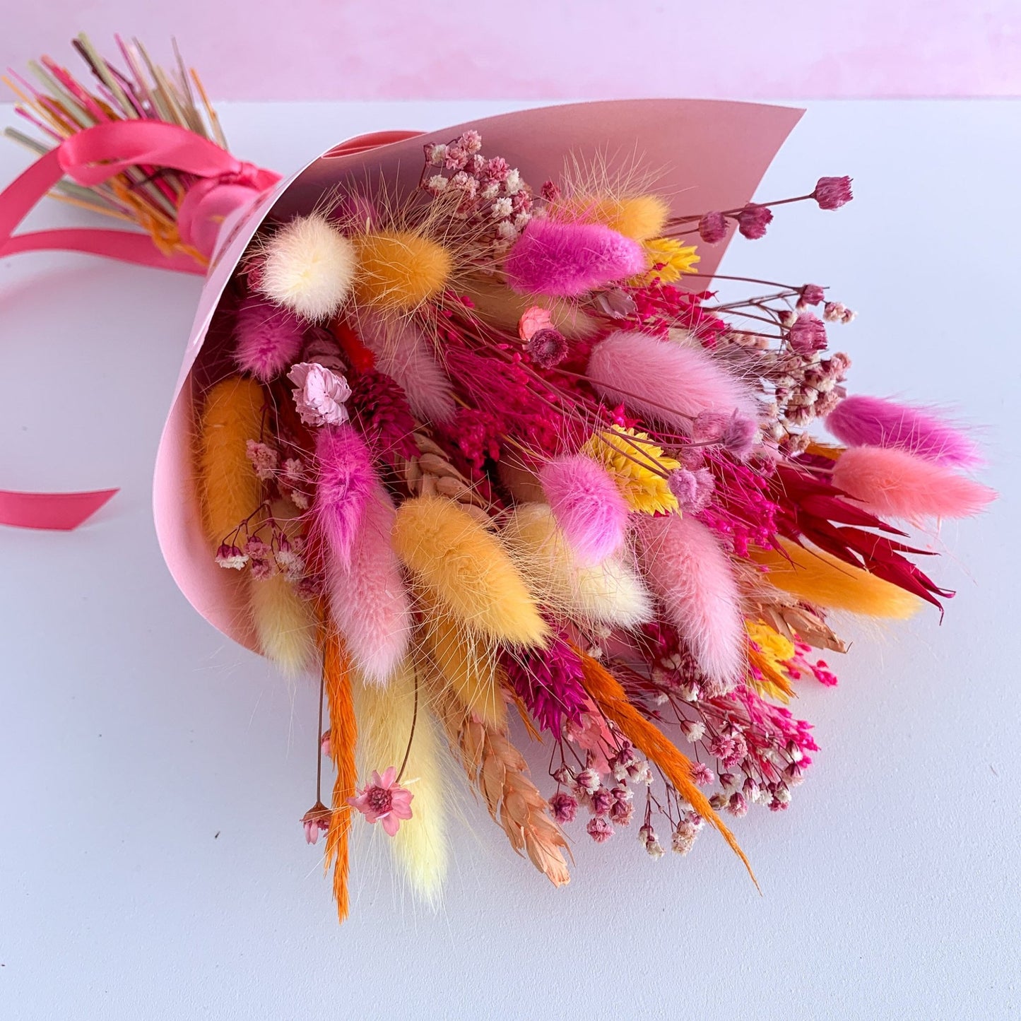 dried flower bouquet in orange and hot pink