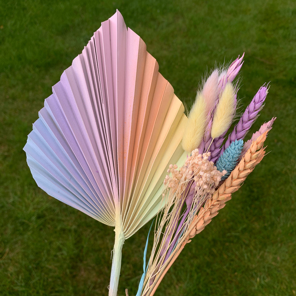 
                      
                        pastel palm spear cake topper with dried flowers
                      
                    