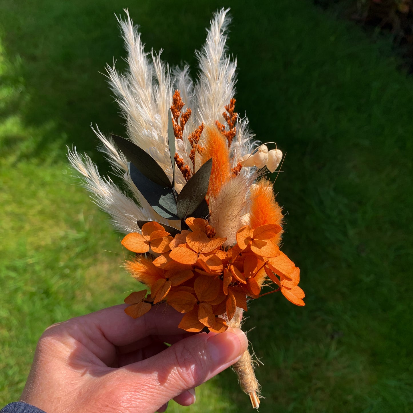 rust orange dried flower buttonhole for autumn wedding