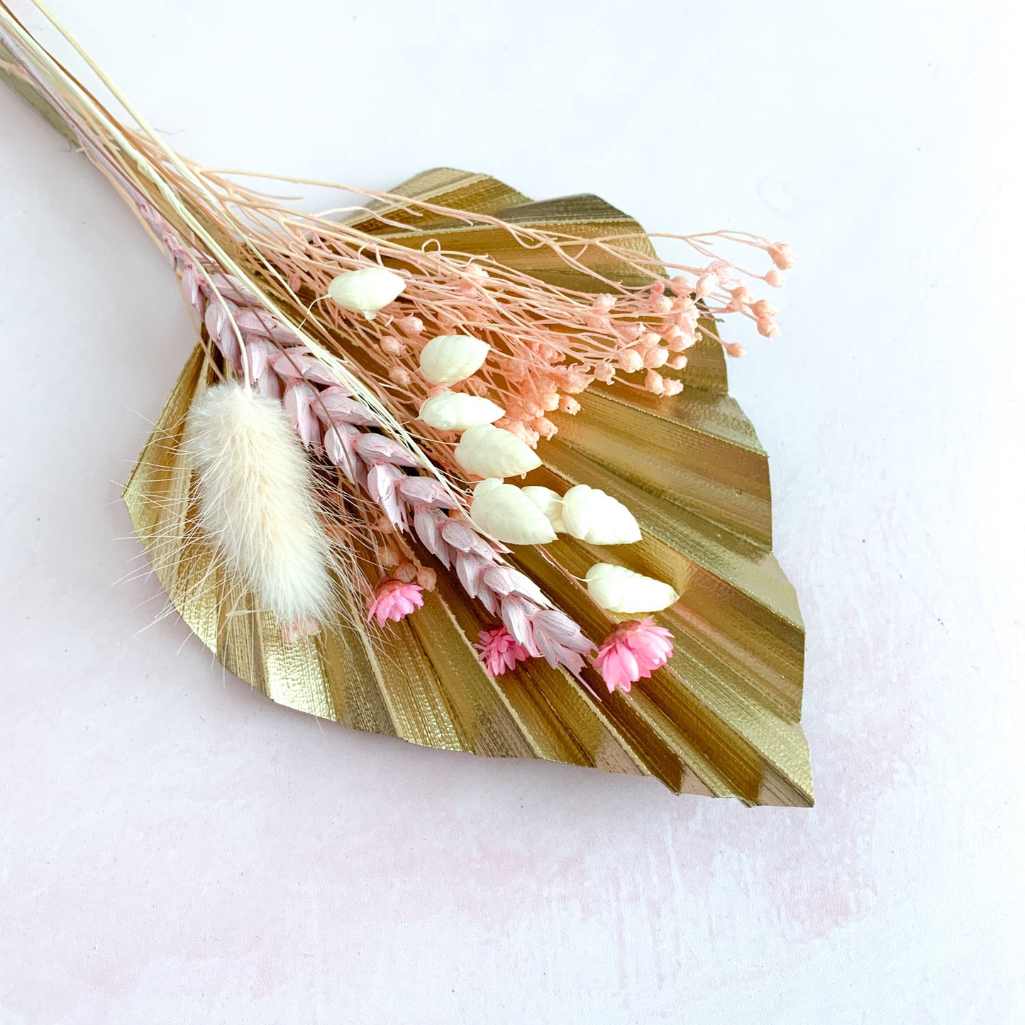 gold palm spear and pink dried flowers